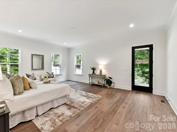 a spacious bedroom with a bed a table and a window