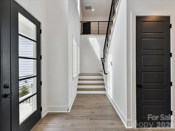 a view of entryway with wooden floor and stairs