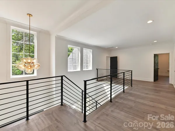 a view of a room with wooden floor and windows