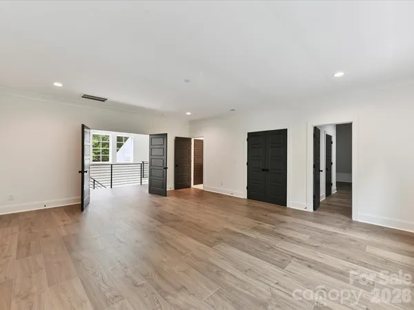 a view of an empty room with closet and window