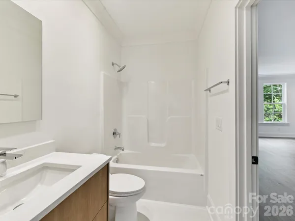a bathroom with a sink toilet vanity and shower