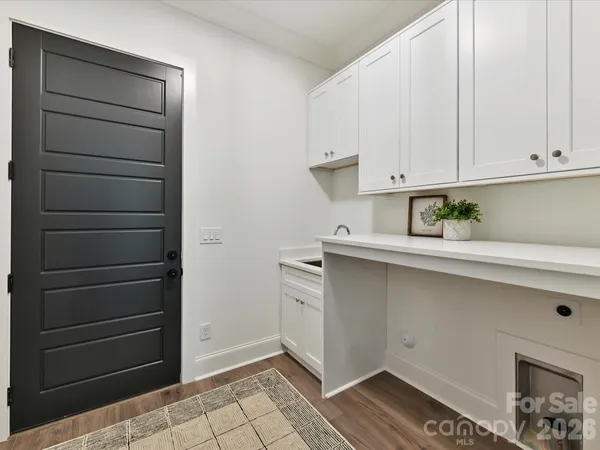 a kitchen with a white cabinets and a stove