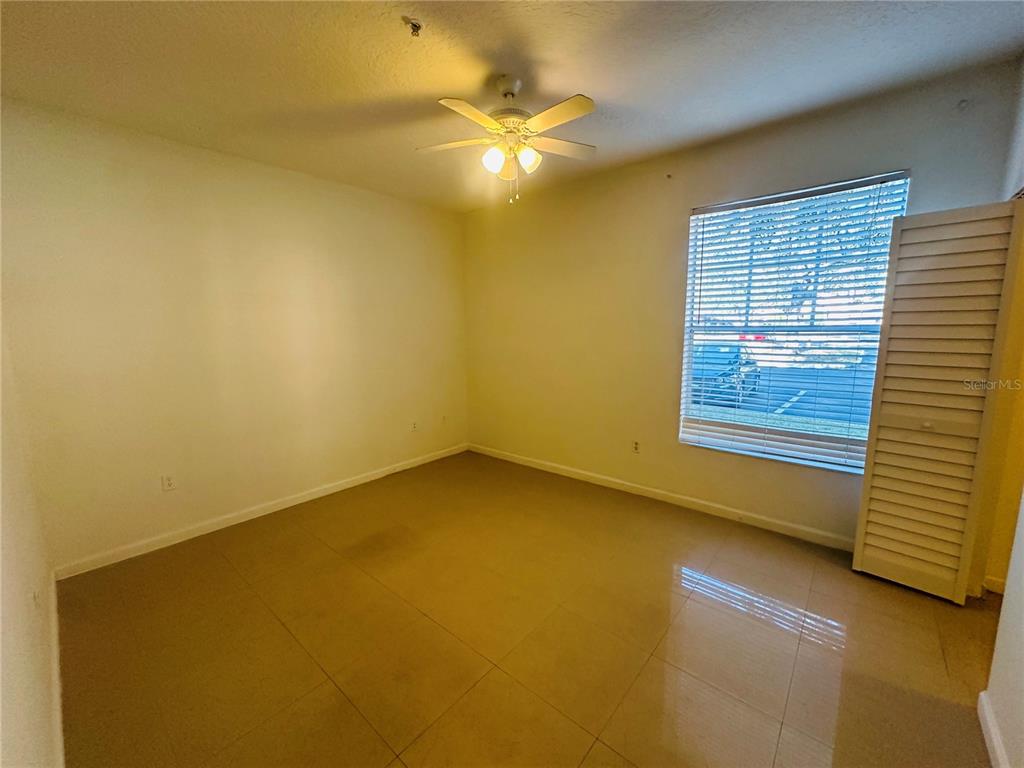 5560 Metrowest Boulevard, Unit 101 Orlando, FL 32811 - Photo 17 of 30 a view of an empty room with a window