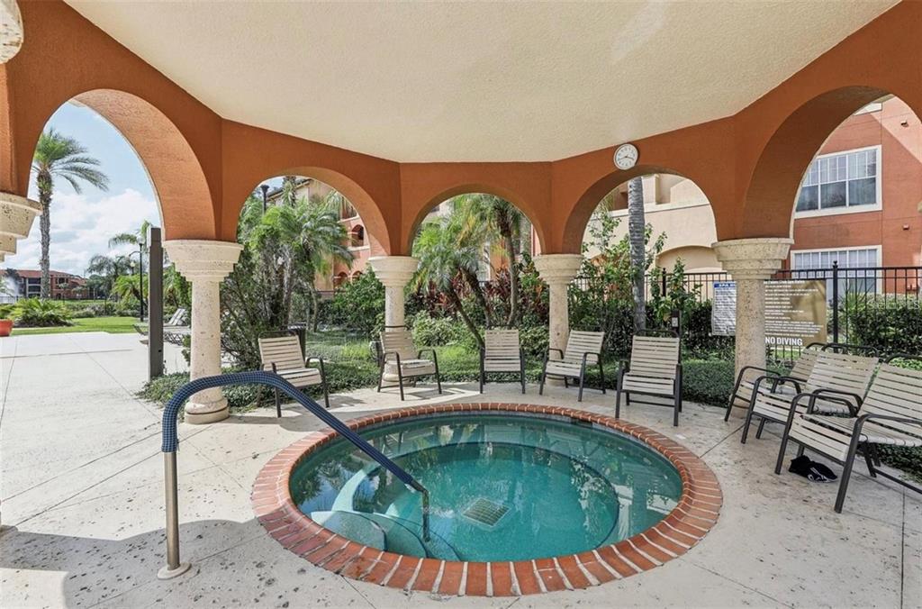 5560 Metrowest Boulevard, Unit 101 Orlando, FL 32811 - Photo 28 of 30 a swimming pool with outdoor seating and yard