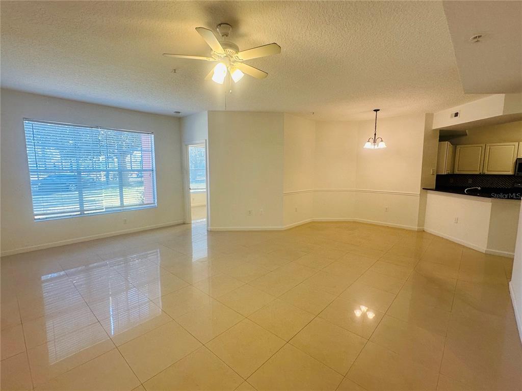 5560 Metrowest Boulevard, Unit 101 Orlando, FL 32811 - Photo 4 of 30 a view of a livingroom with a kitchen