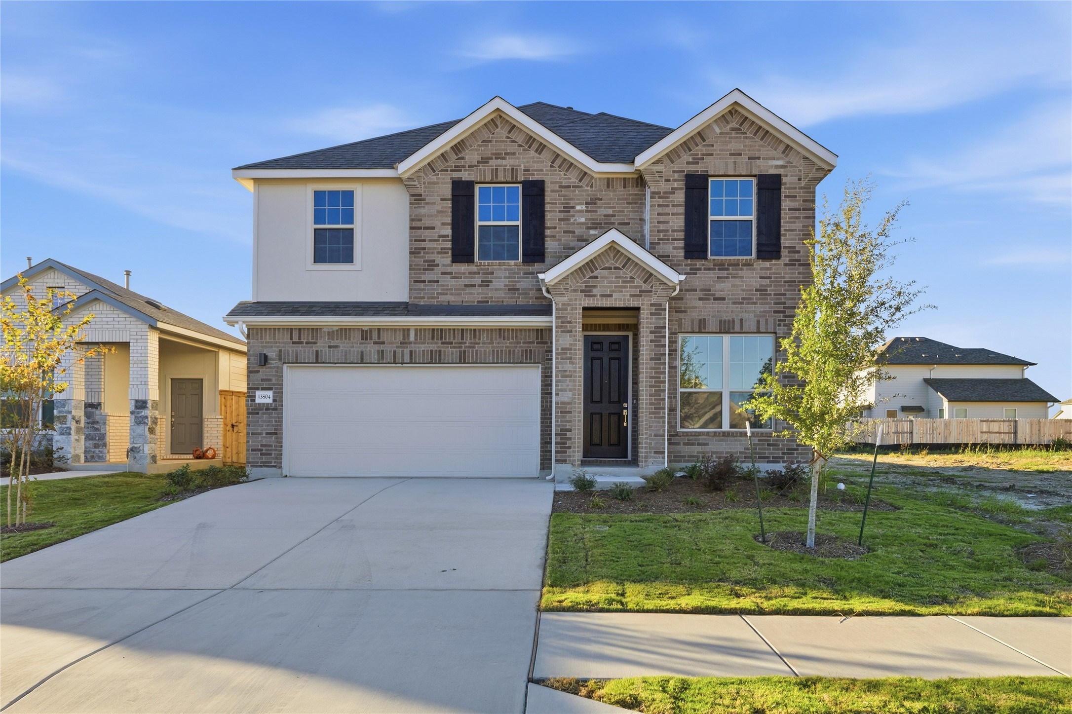 13804 Tucker Hedge Pass Elgin, TX 78621 - Photo 1 of 1 a front view of a house with a yard and garage