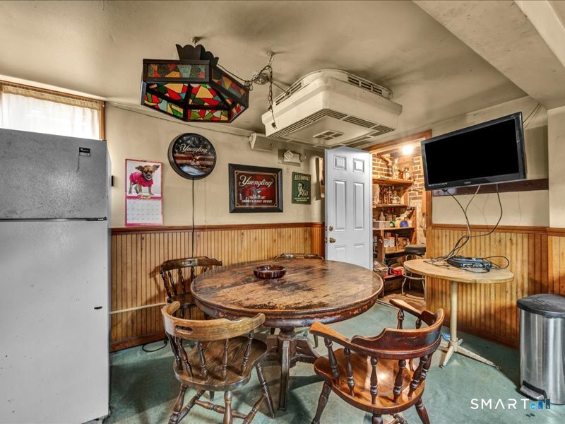 61 Maple Avenue Wallingford, CT 06492 - Photo 16 of 20 a view of a dining room with furniture and a flat screen tv