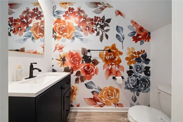 a bathroom with a sink and mirror with toilet
