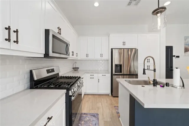 a kitchen with a sink stove and refrigerator