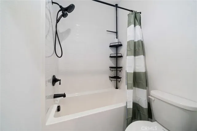 a white bath tub sitting next to a white toilet and sink