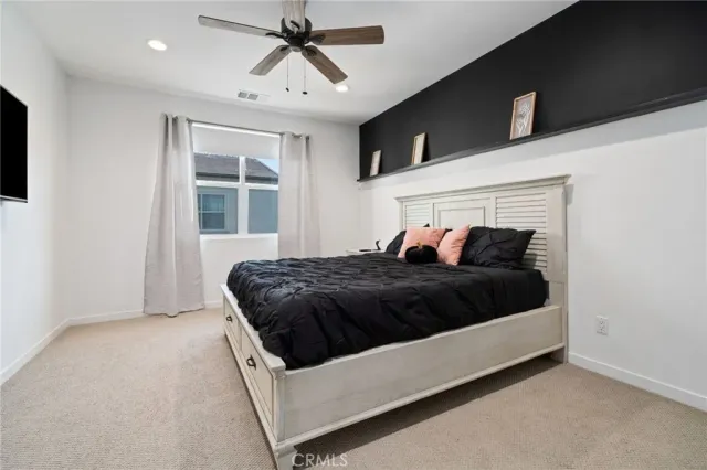 a bedroom with a large bed and a window