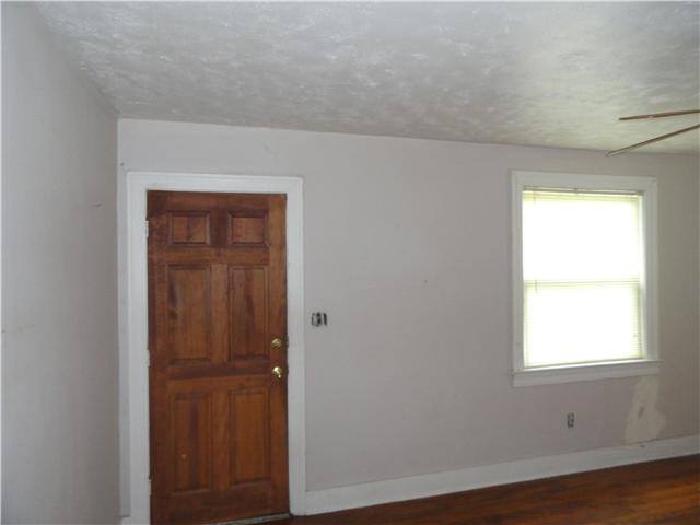603 Neelys Bend Road Madison, TN 37115 - Photo 3 of 10 an empty room with wooden floor closet and windows