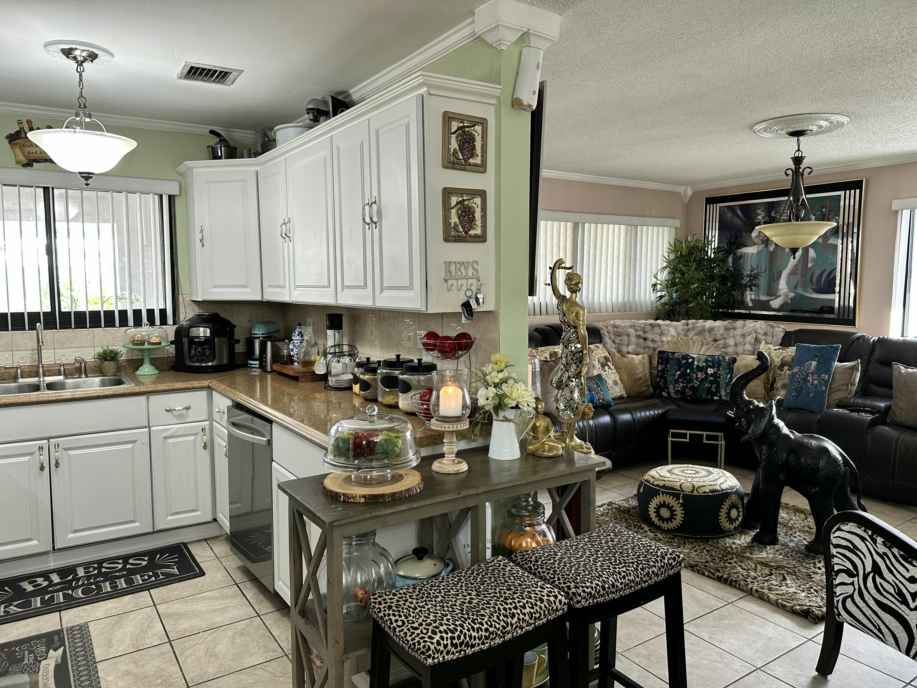 2922 Flagler Avenue Key West, FL 33040 - Photo 15 of 53 a kitchen with a dining table chairs and white appliances