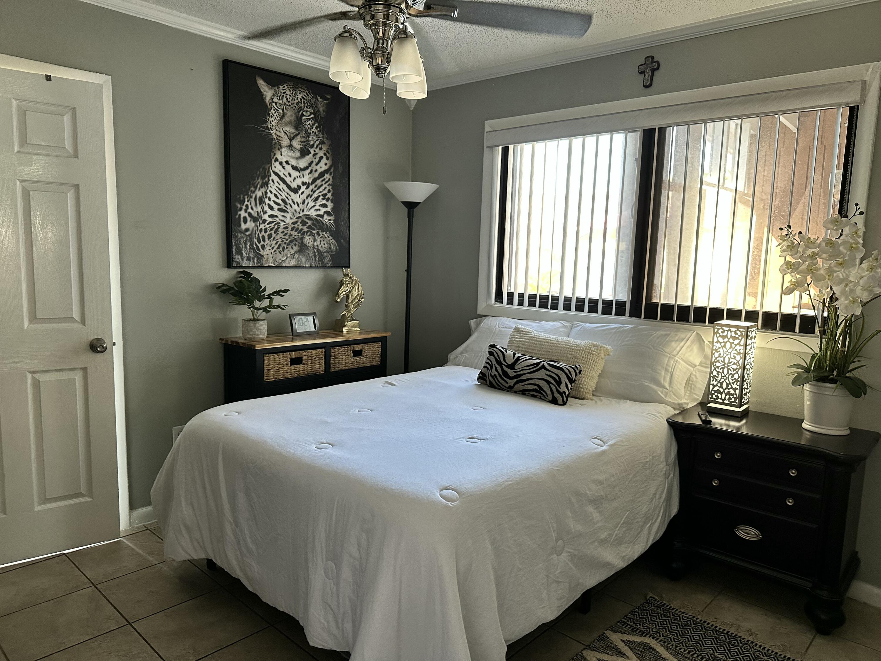2922 Flagler Avenue Key West, FL 33040 - Photo 31 of 53 a bedroom with a bed and a chandelier