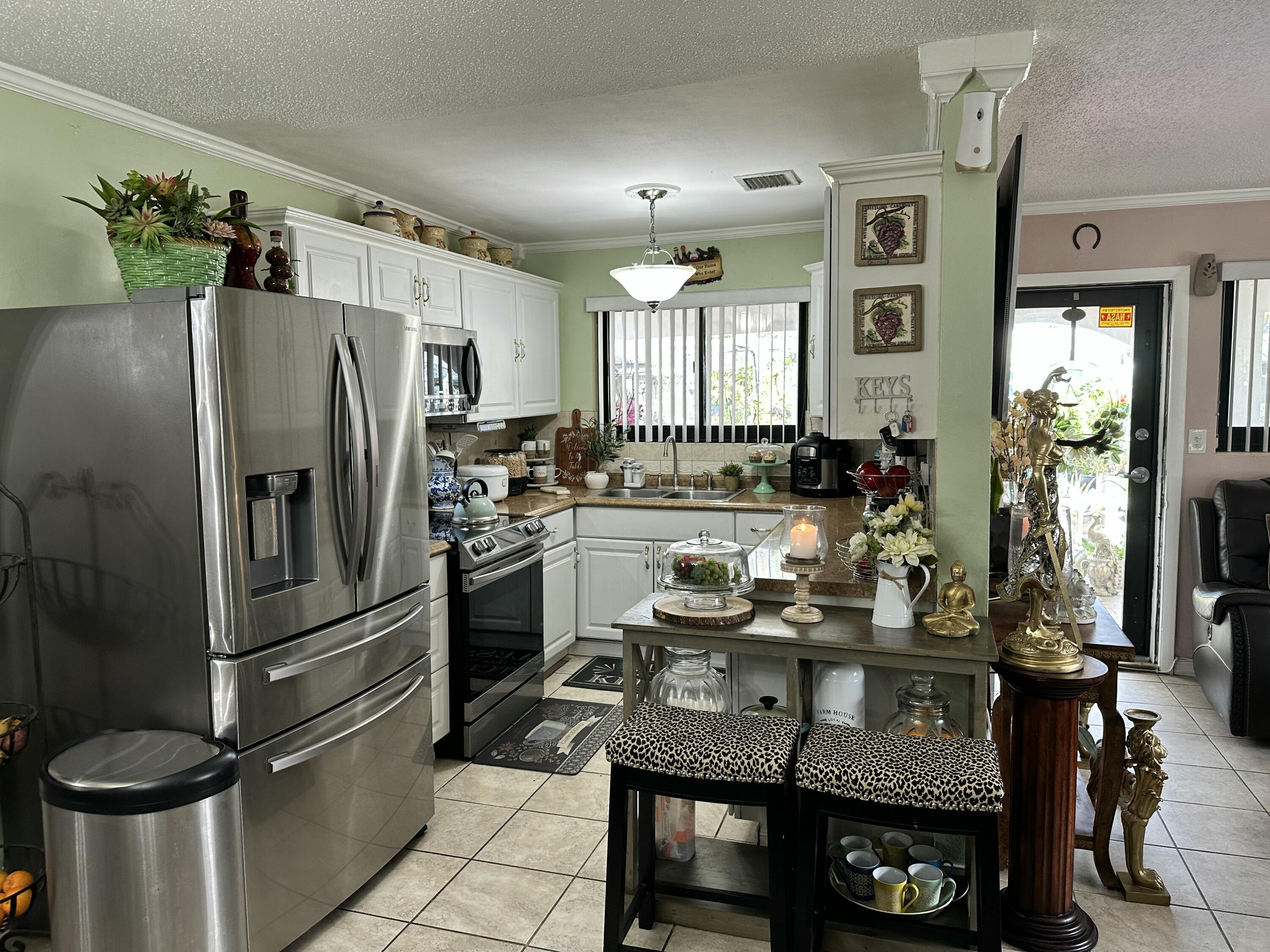 2922 Flagler Avenue Key West, FL 33040 - Photo 32 of 53 a kitchen with sink refrigerator and outdoor view