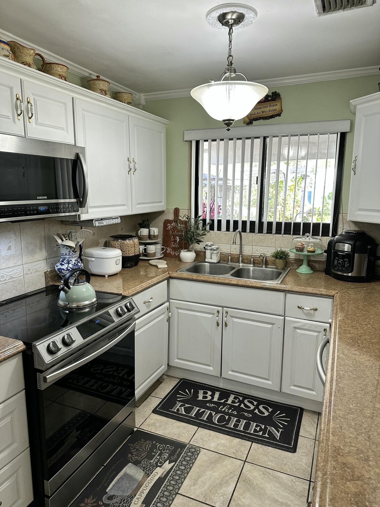 2922 Flagler Avenue Key West, FL 33040 - Photo 37 of 53 a kitchen with a stove a sink and a microwave