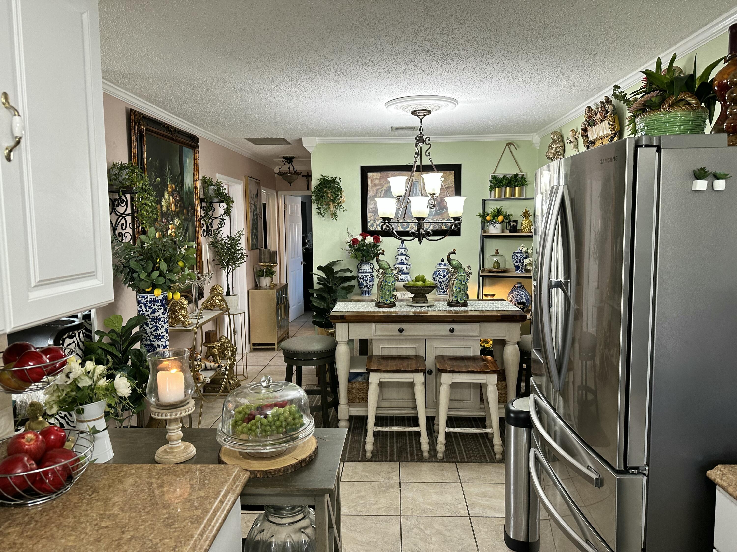2922 Flagler Avenue Key West, FL 33040 - Photo 4 of 53 a kitchen with a refrigerator and potted plant