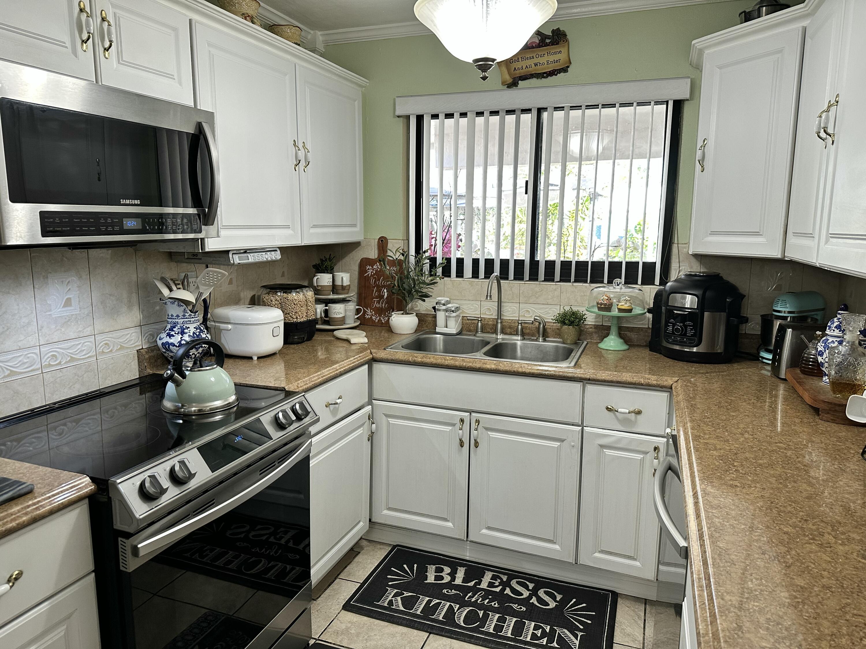 2922 Flagler Avenue Key West, FL 33040 - Photo 6 of 53 a kitchen with a stove a sink and a microwave