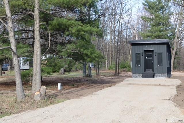 1545 South La Chance Road Lake City, MI 49651 - Photo 20 of 51 View of community featuring driveway and an outdoor structure