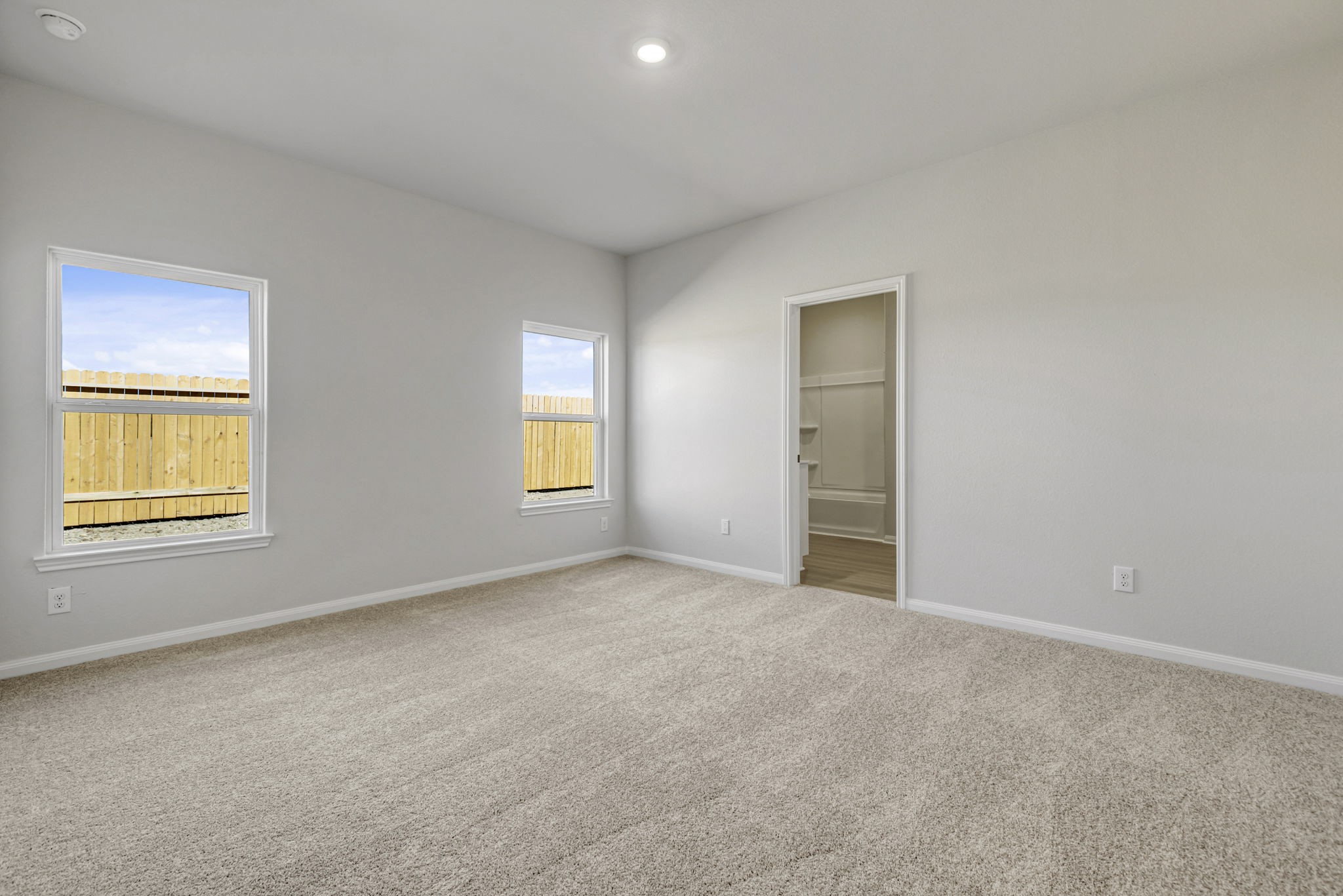 6419 Winter Elm Street Houston, TX 77048 - Photo 3 of 7 an empty room with windows and closet