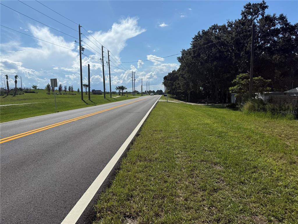 630 Kokomo Road Haines City, FL 33844 - Photo 2 of 6 a view of a house with a big yard and potted plants
