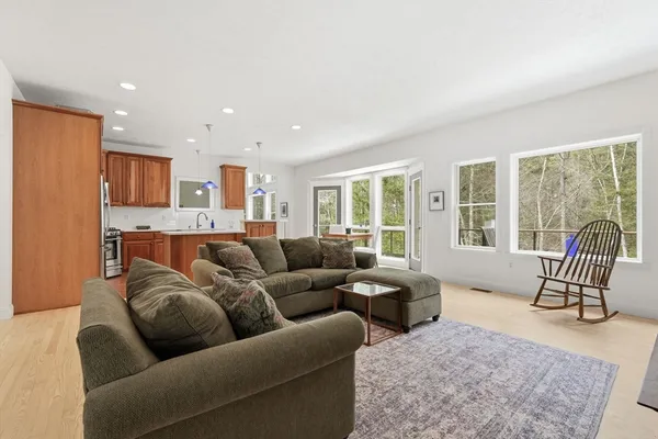 a living room with furniture and a floor to ceiling window