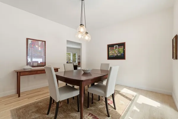 a view of a dining room with furniture and a chandelier