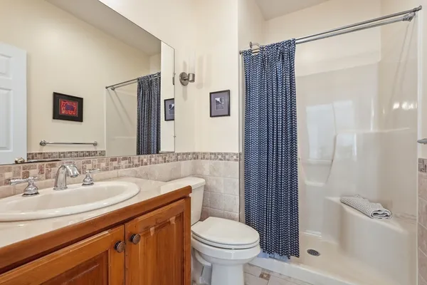 a bathroom with a sink toilet and shower