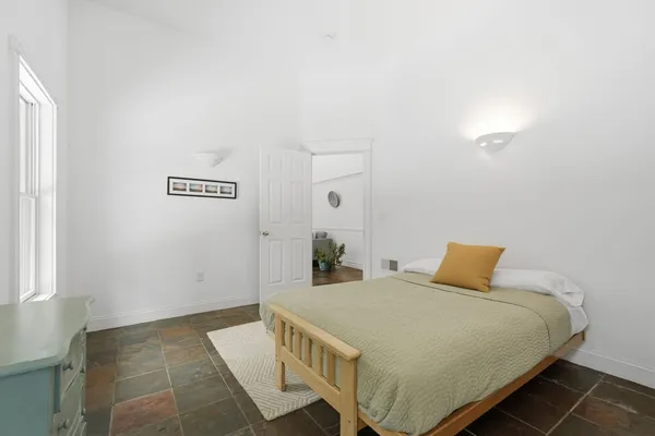 a bedroom with a bed and a table