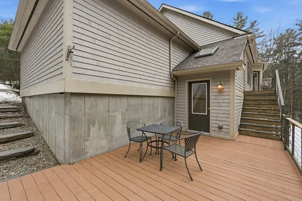a view of a wooden chairs on the deck