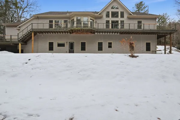 a big white house with a large tree in front of it