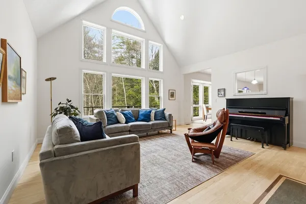 a living room with furniture and a piano