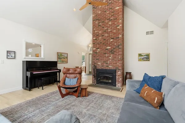a living room with furniture a fireplace and a table