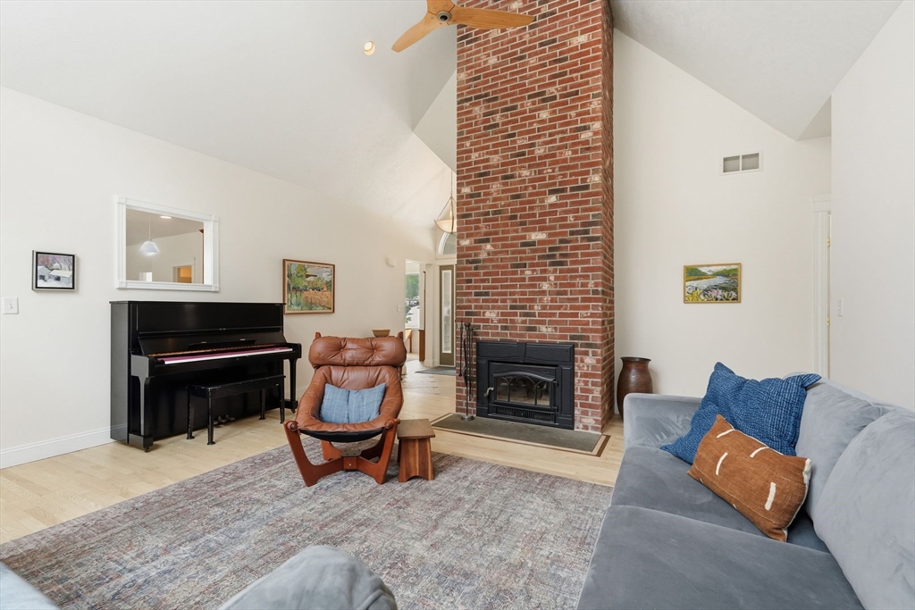 16 North Valley Road Pelham, MA 01002 - Photo 6 of 41 a living room with furniture a fireplace and a table