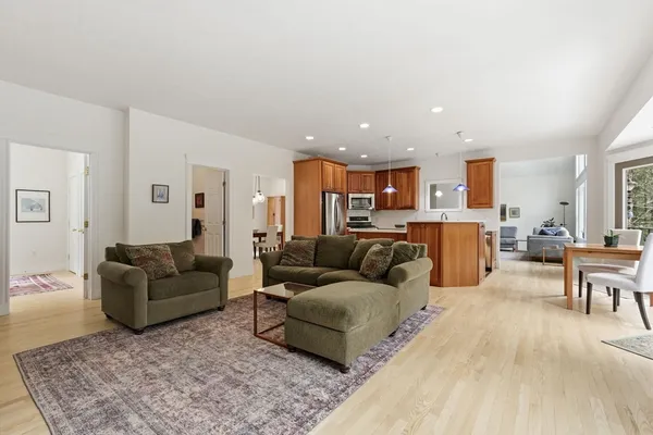 a living room with furniture and kitchen view