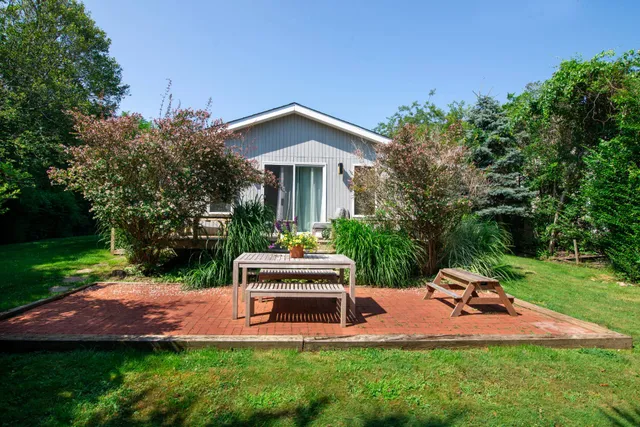 a front view of a house with a yard table and chairs