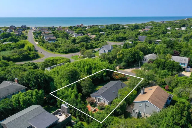 an aerial view of a house with a yard
