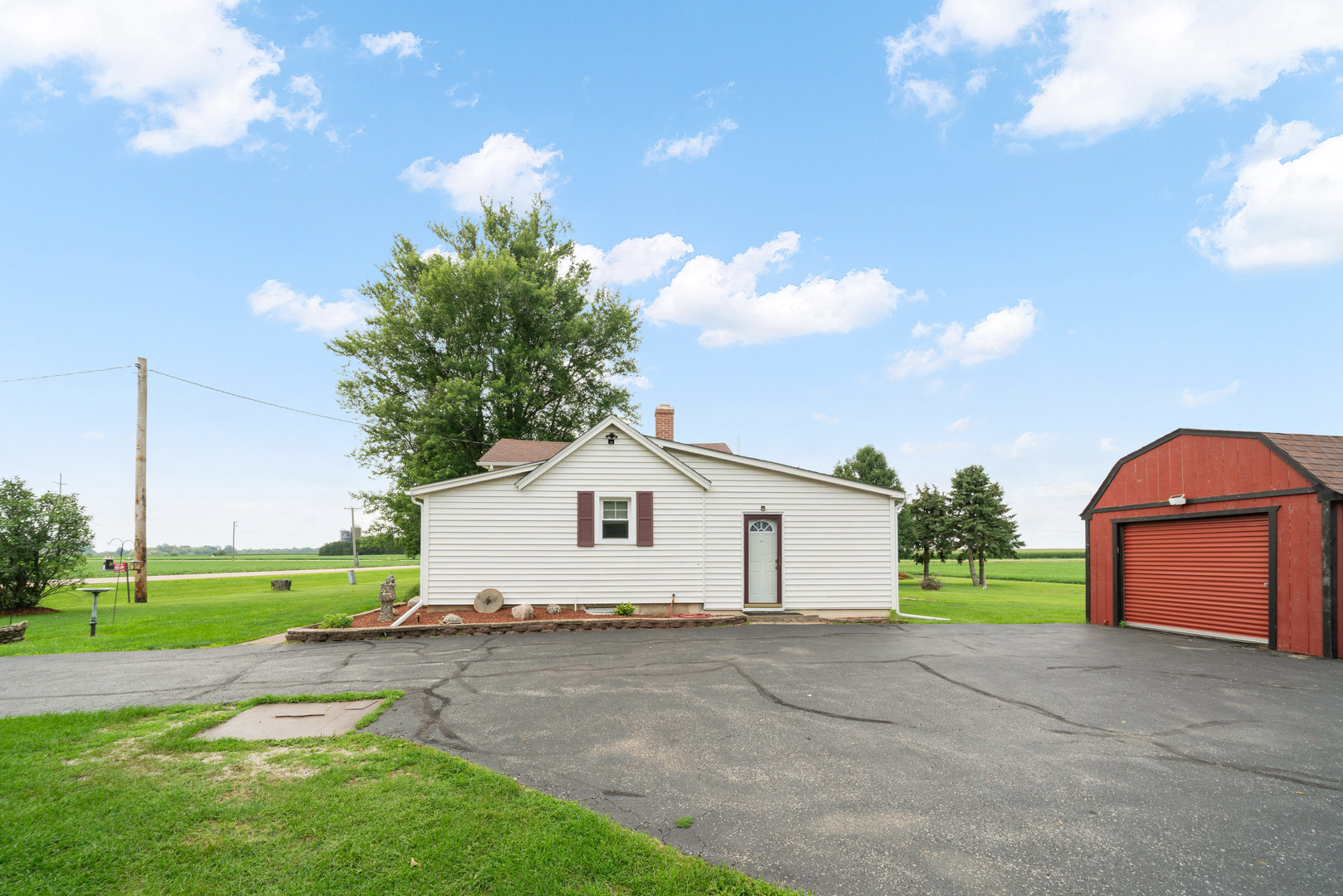 15589 Chicago Road Sandwich, IL 60548 - Photo 24 of 30 a view of a house with a backyard and a garage