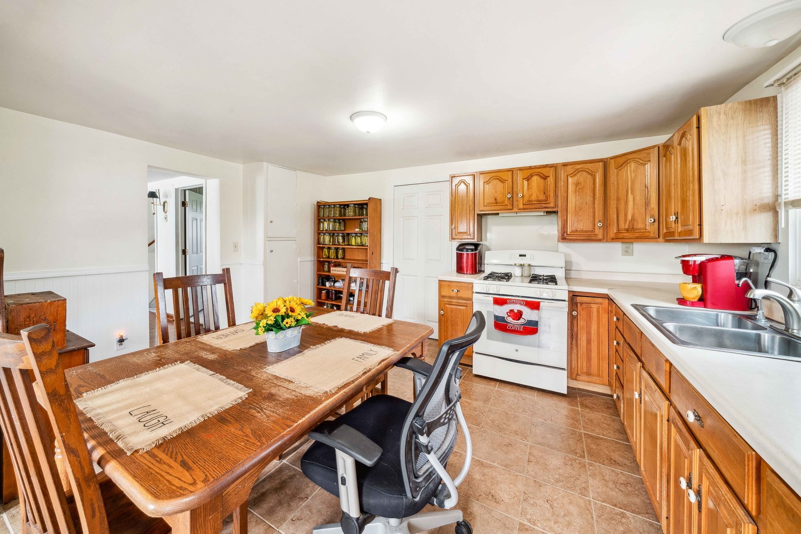 15589 Chicago Road Sandwich, IL 60548 - Photo 7 of 30 a kitchen with a dining table chairs and white appliances