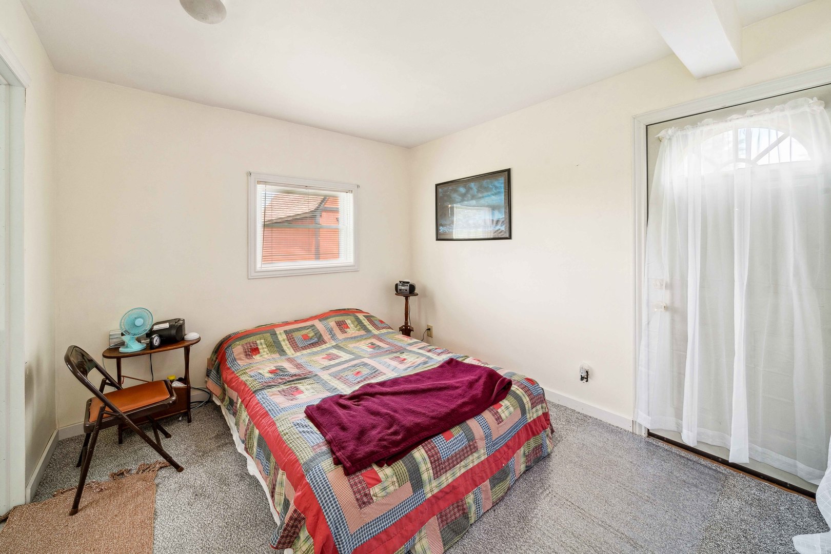 15589 Chicago Road Sandwich, IL 60548 - Photo 8 of 30 a bedroom with a bed and a table in it