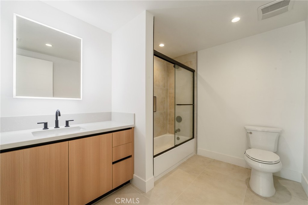 7510 Sepulveda Boulevard, Unit 204 Van Nuys, CA 91405 - Photo 19 of 24 a bathroom with a toilet sink and shower