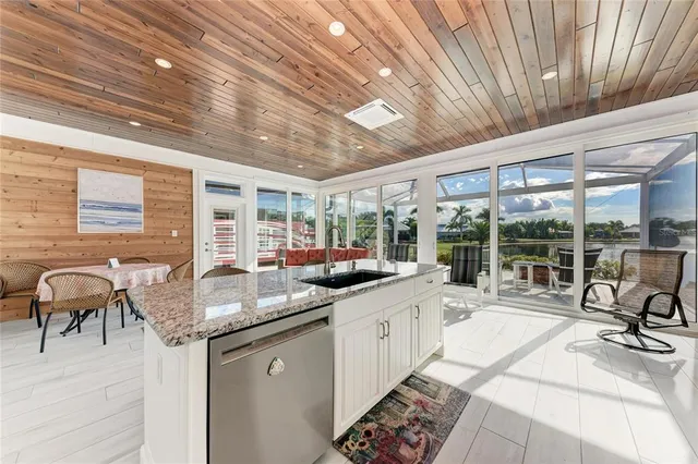 a white refrigerator freezer and a stove sitting inside of a kitchen