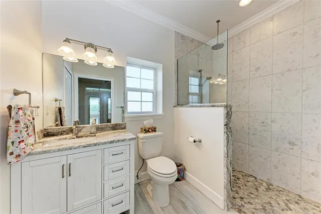 a patio with wooden floor a yard a table and chairs