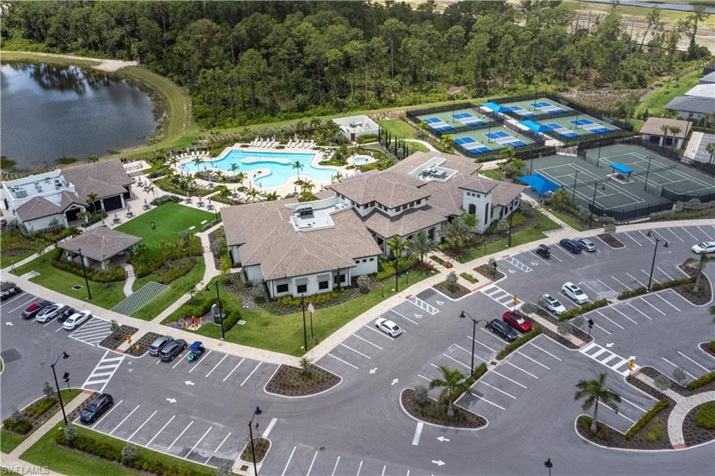 2104 Freemont Way Naples, FL 34119 - Photo 20 of 27 aerial view of clubhouse, pavilion bar and restaurant, pool and pickleball and tennis courts