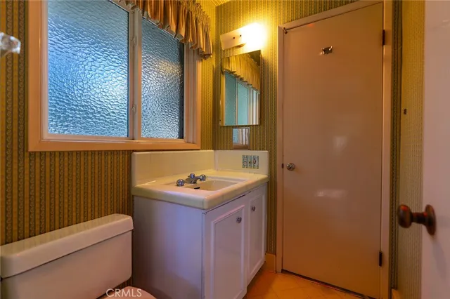 a bathroom with a sink toilet vanity and shower