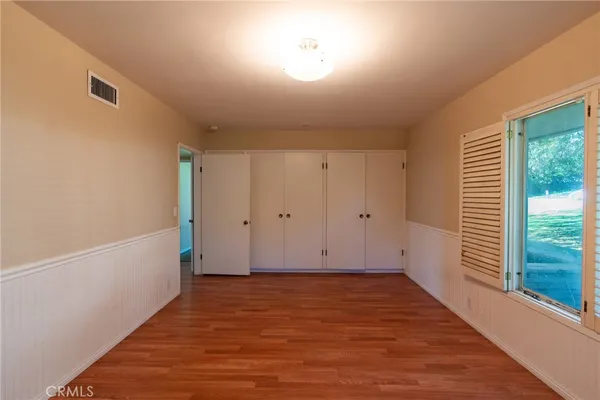 a view of room with window and hardwood floor