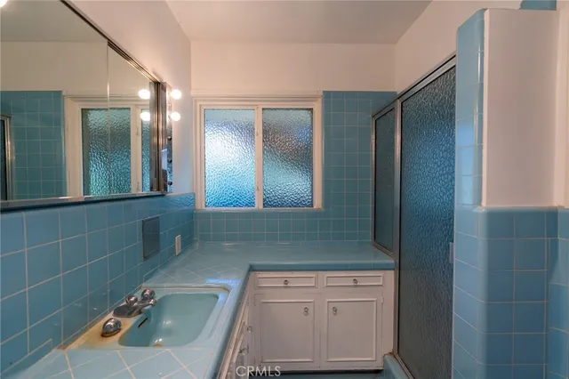 a bathroom with a sink a toilet and mirror