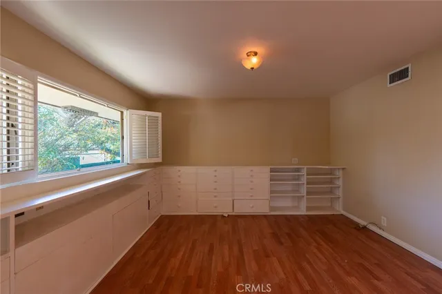 a view of wooden floor and windows in a room