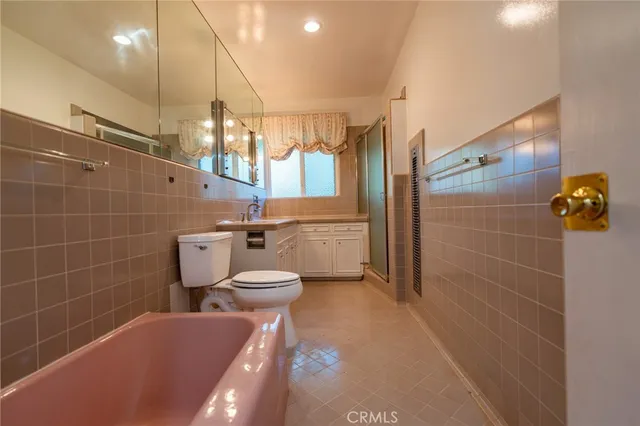 a bathroom with a toilet a sink and shower