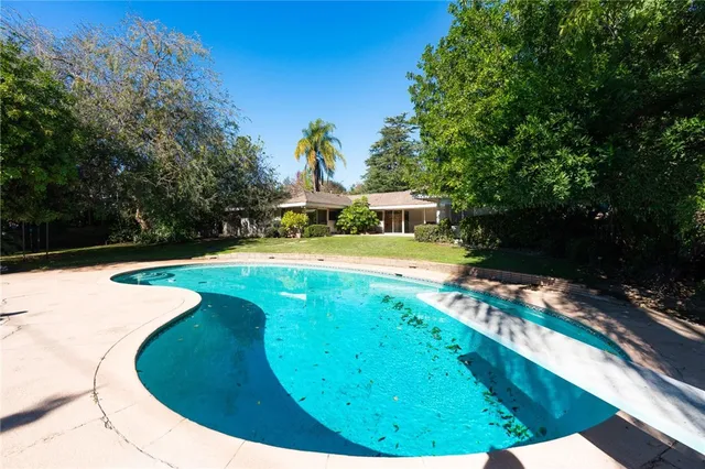a view of a swimming pool with a yard